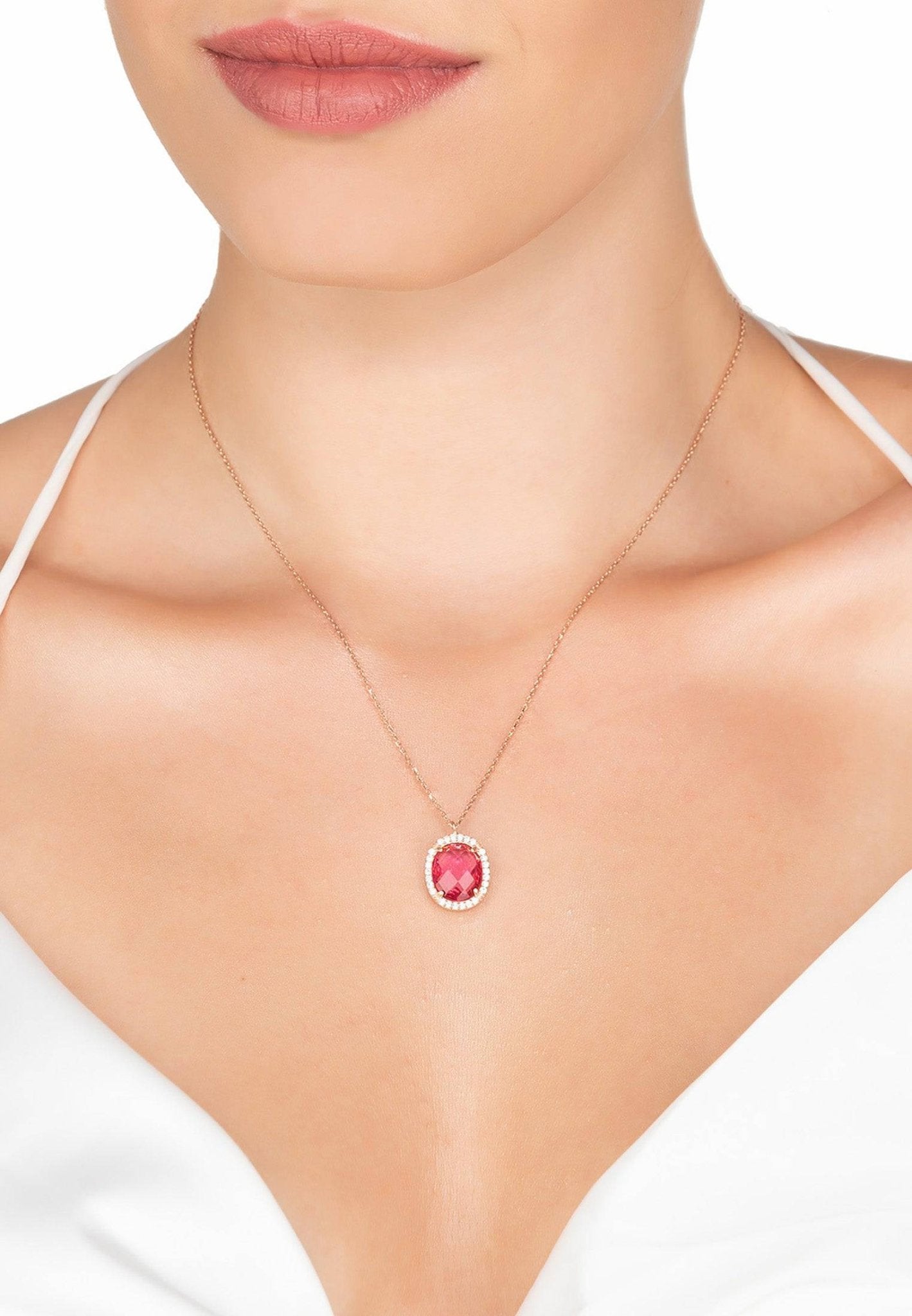 Necklace with a red gemstone pendant on a model's neck.