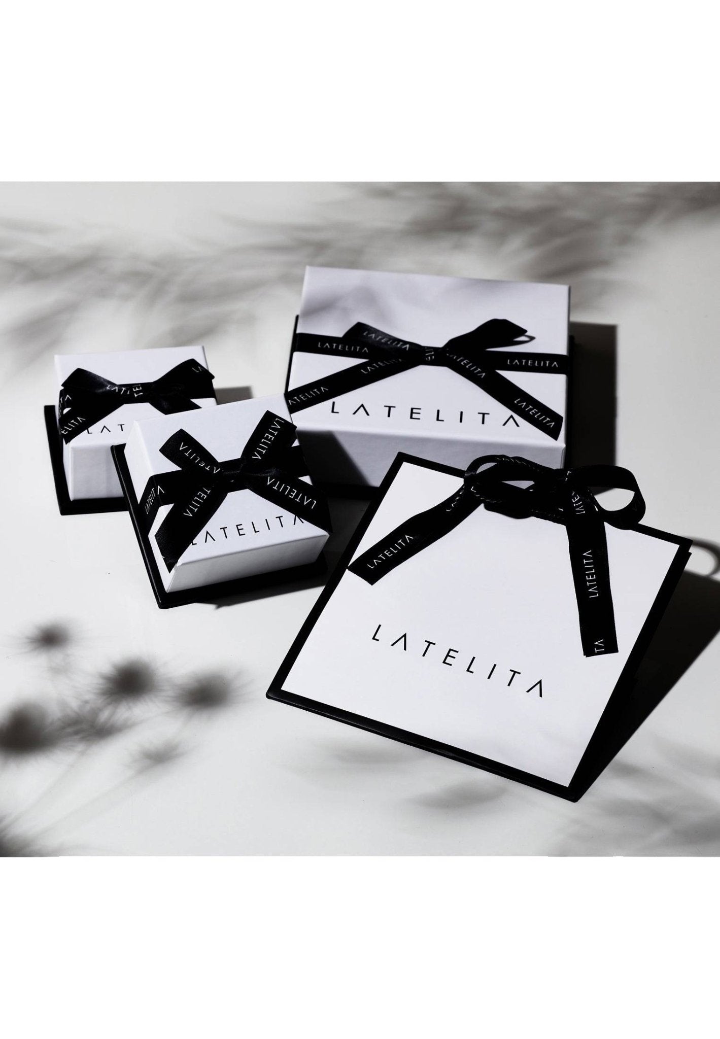 LATELITA boxes with black ribbons on a light background