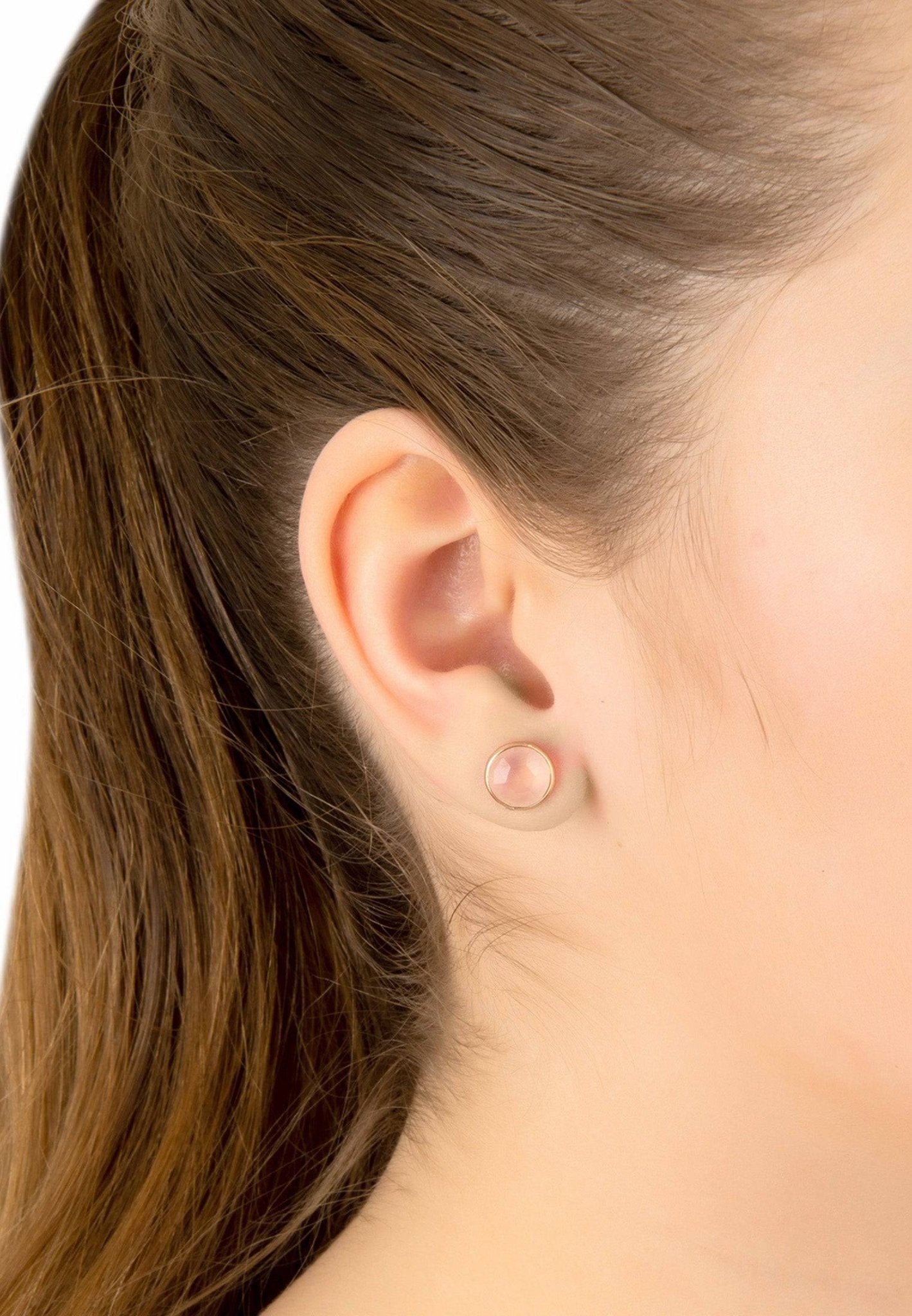 Close-up of a person's ear with a small earring.