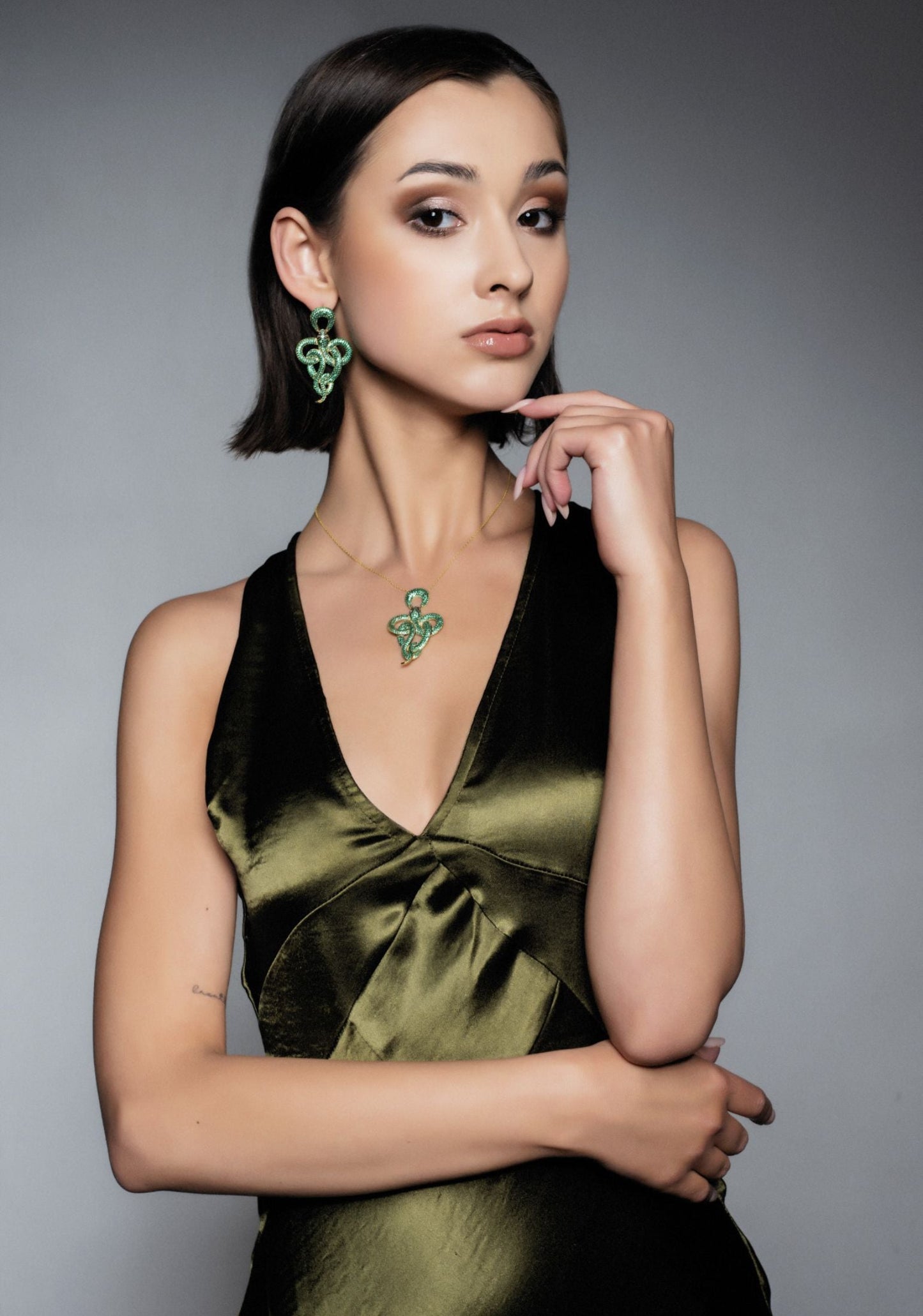 Viper snake drop earrings gold emerald